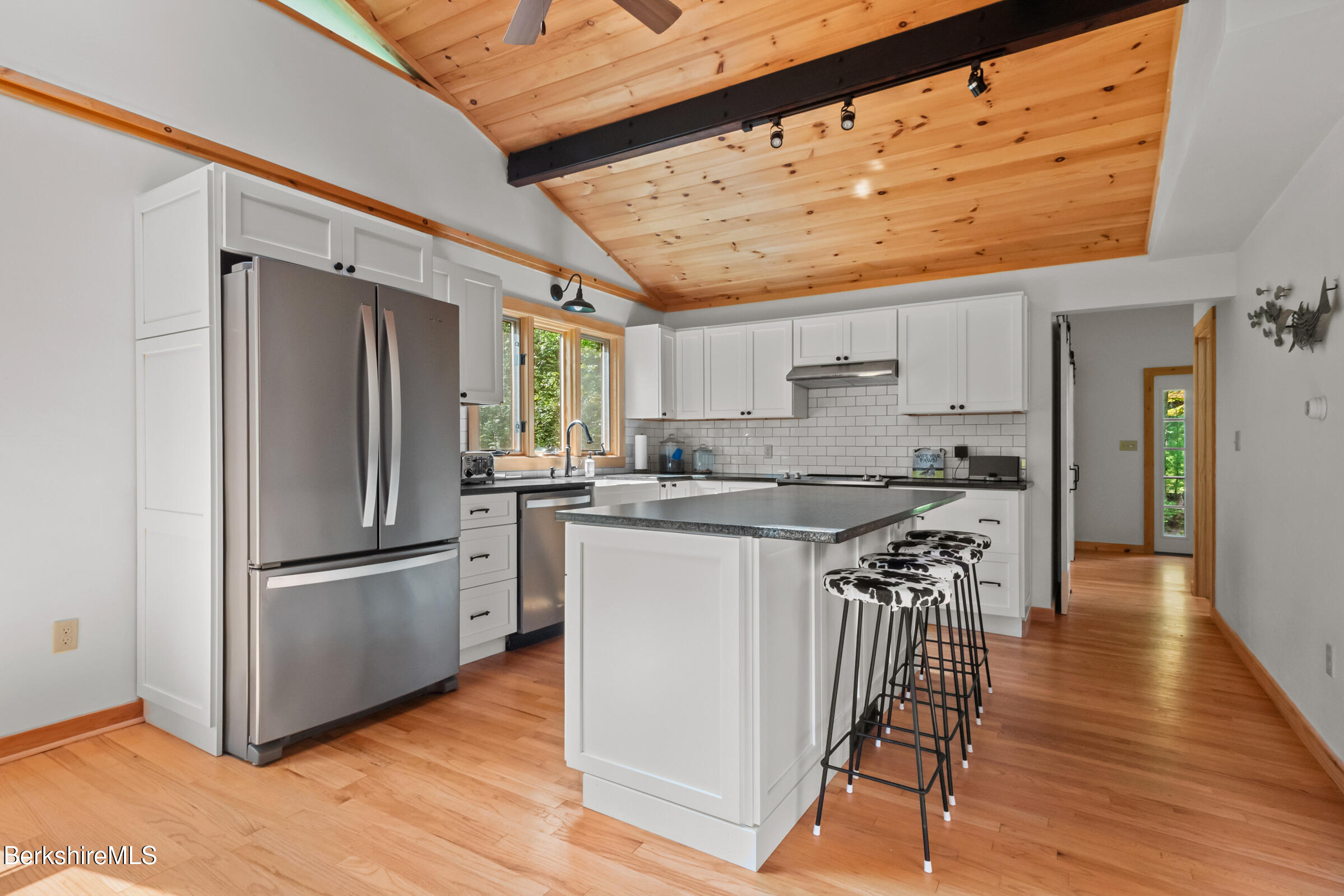 10 Phelps Road Monterey, MA 01245 - Photo 15 of 45 a kitchen with stainless steel appliances granite countertop a refrigerator a sink dishwasher a stove and white countertops with wooden floor