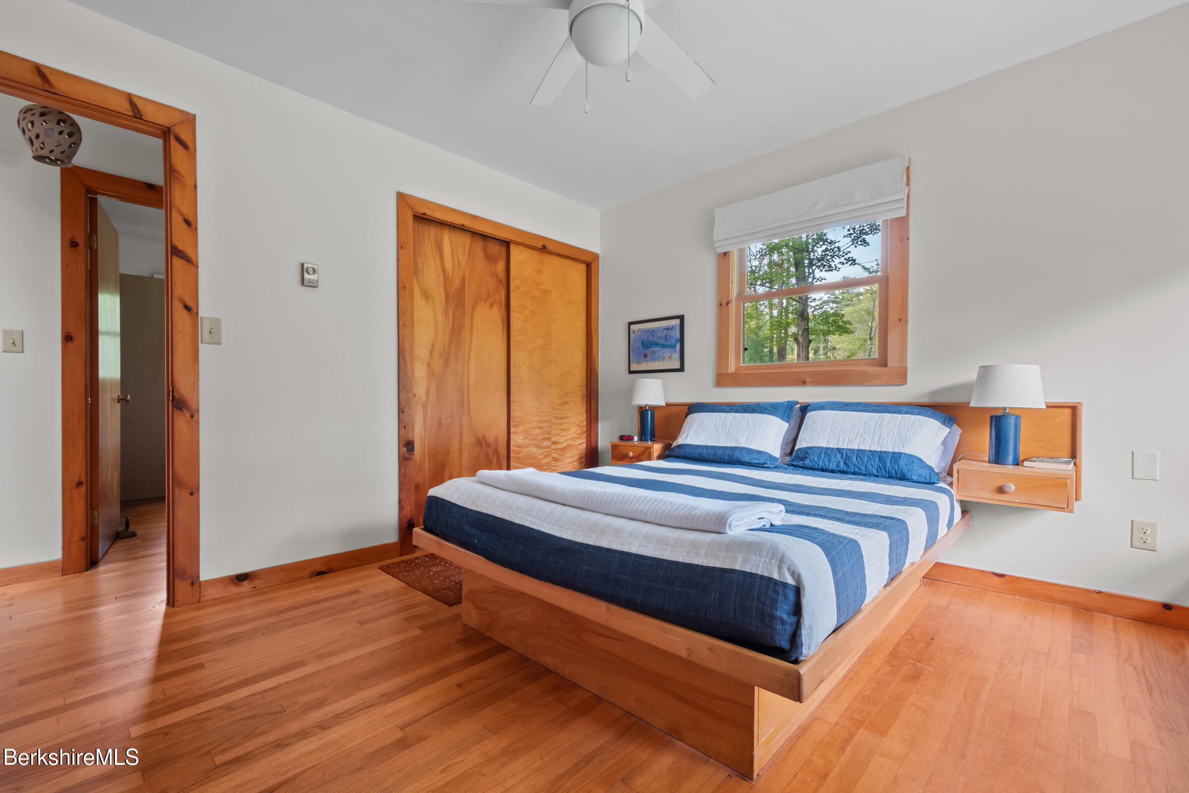 10 Phelps Road Monterey, MA 01245 - Photo 27 of 45 a bedroom with a bed and wooden floor