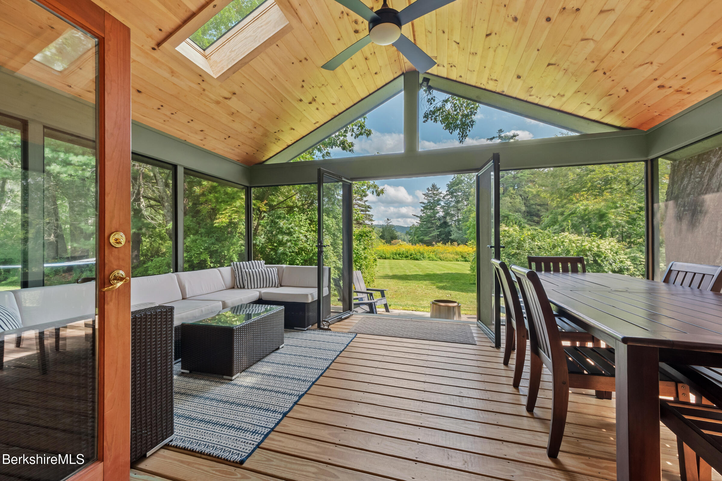 10 Phelps Road Monterey, MA 01245 - Photo 34 of 45 a view of a patio with table and chairs potted plants with wooden floor and fence