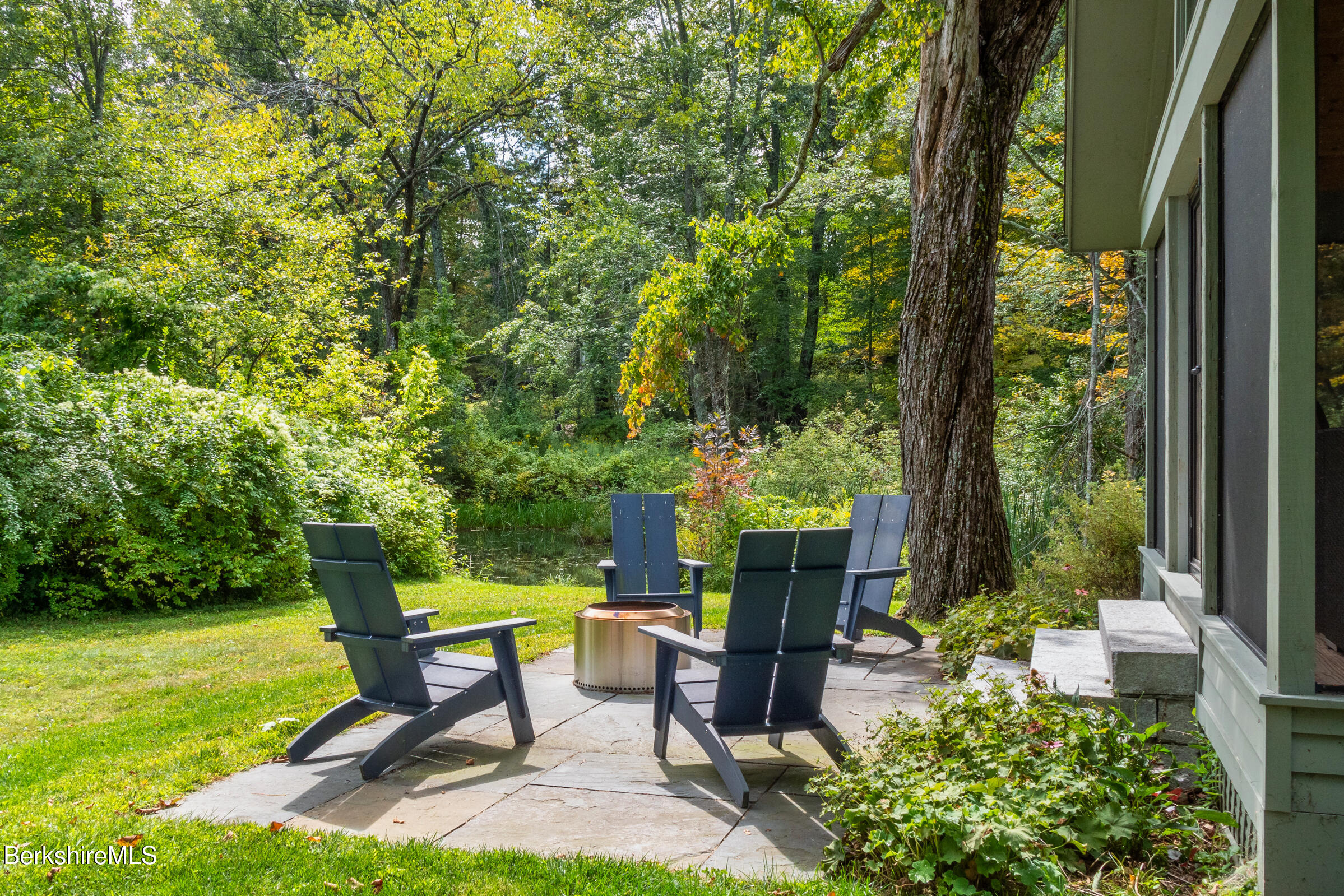 10 Phelps Road Monterey, MA 01245 - Photo 39 of 45 a view of a chair and table in backyard of a house