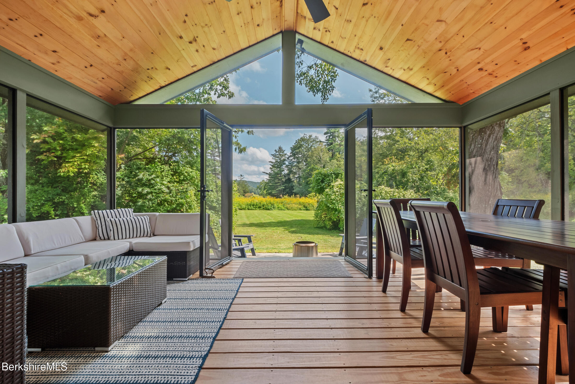 10 Phelps Road Monterey, MA 01245 - Photo 6 of 45 a view of a patio with lawn chairs next to a yard