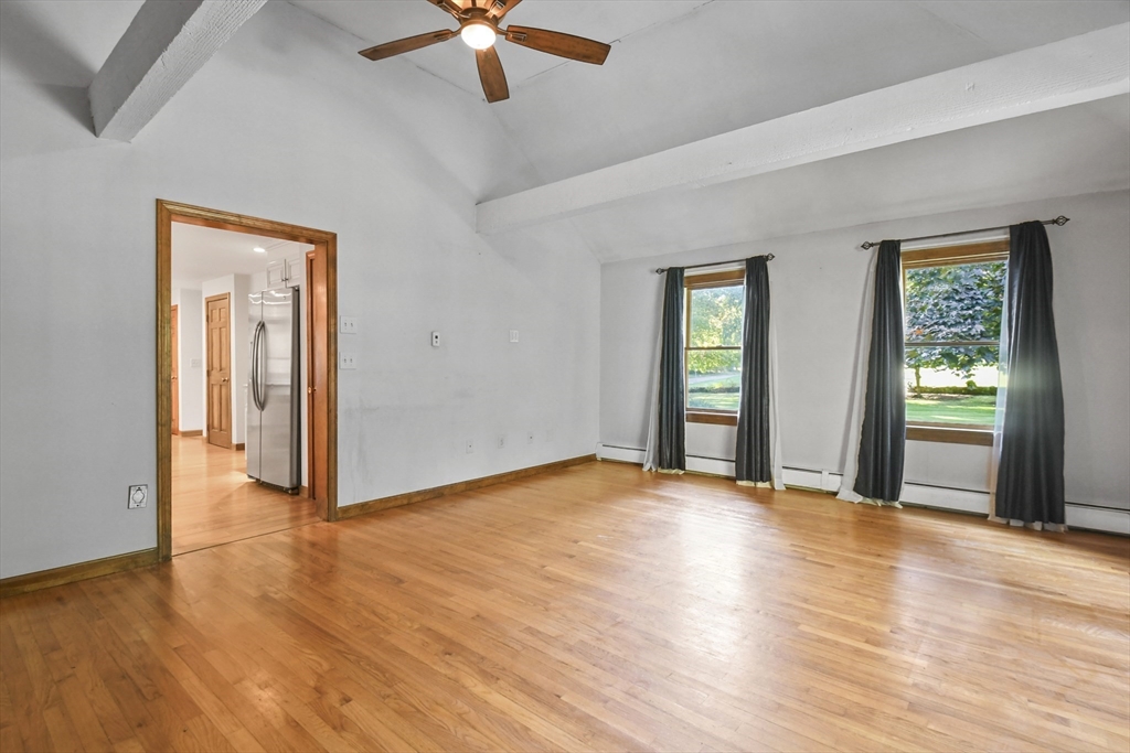 11 Oregon Road Tyngsboro, MA 01879 - Photo 13 of 41 a view of an empty room with window and wooden floor