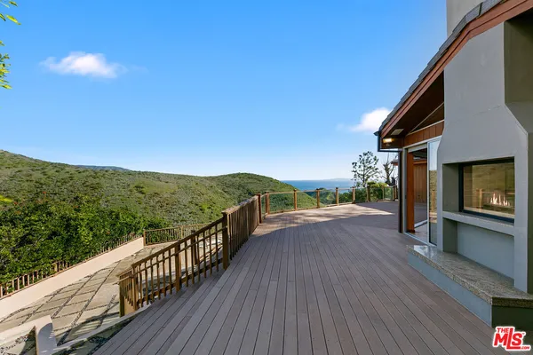 a view of a balcony with a yard