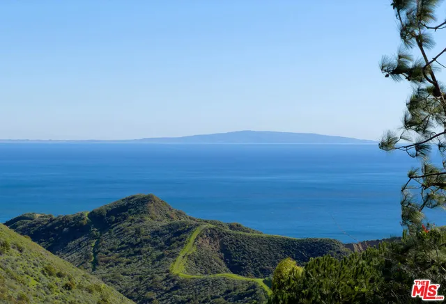 a bedroom with a bed a flat screen tv and balcony