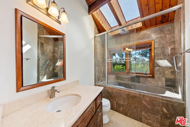 a balcony with furniture and a potted plant