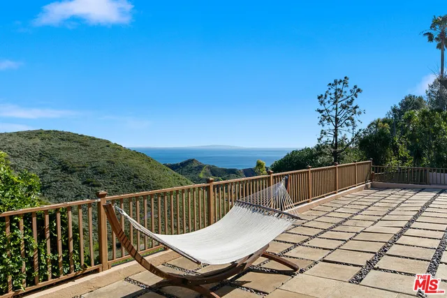 a front view of a house with a garden and yard
