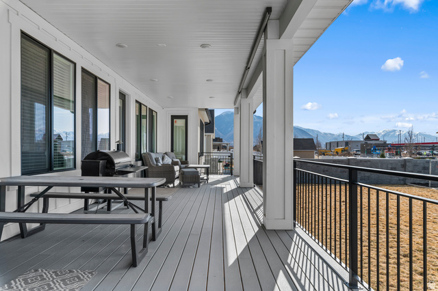 1426 South 1450th Street West Mapleton, UT 84664 - Photo 39 of 50 Expansive covered deck featuring composite flooring, white paneled ceiling, recessed lighting, and black metal railing