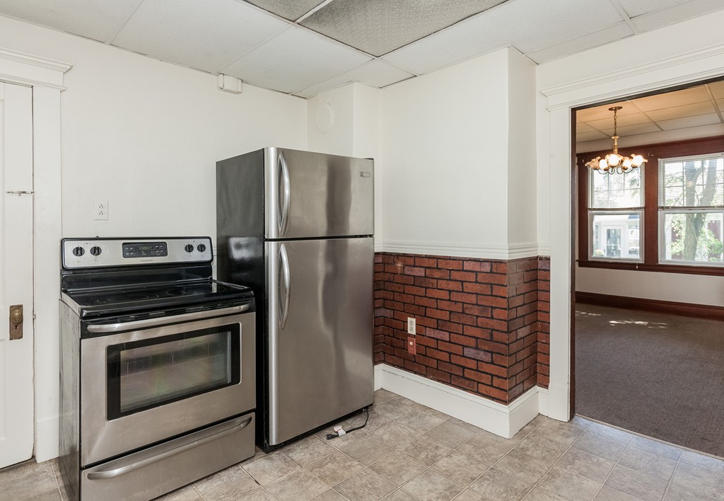 110 Hood Street Springfield, MA 01109 - Photo 12 of 17 a kitchen with a stove a fridge and a window