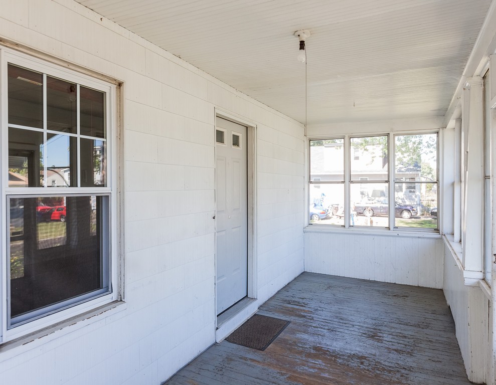 110 Hood Street Springfield, MA 01109 - Photo 4 of 17 an empty room with wooden floor and windows