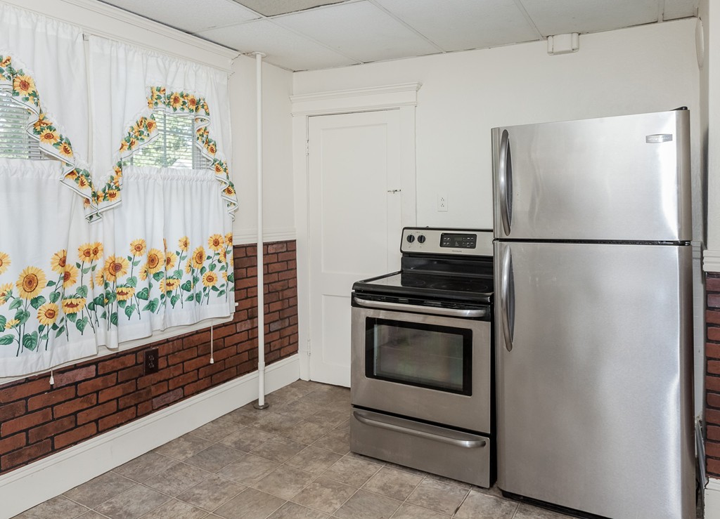 110 Hood Street Springfield, MA 01109 - Photo 10 of 17 a view of kitchen with stainless steel appliances wooden floor and window