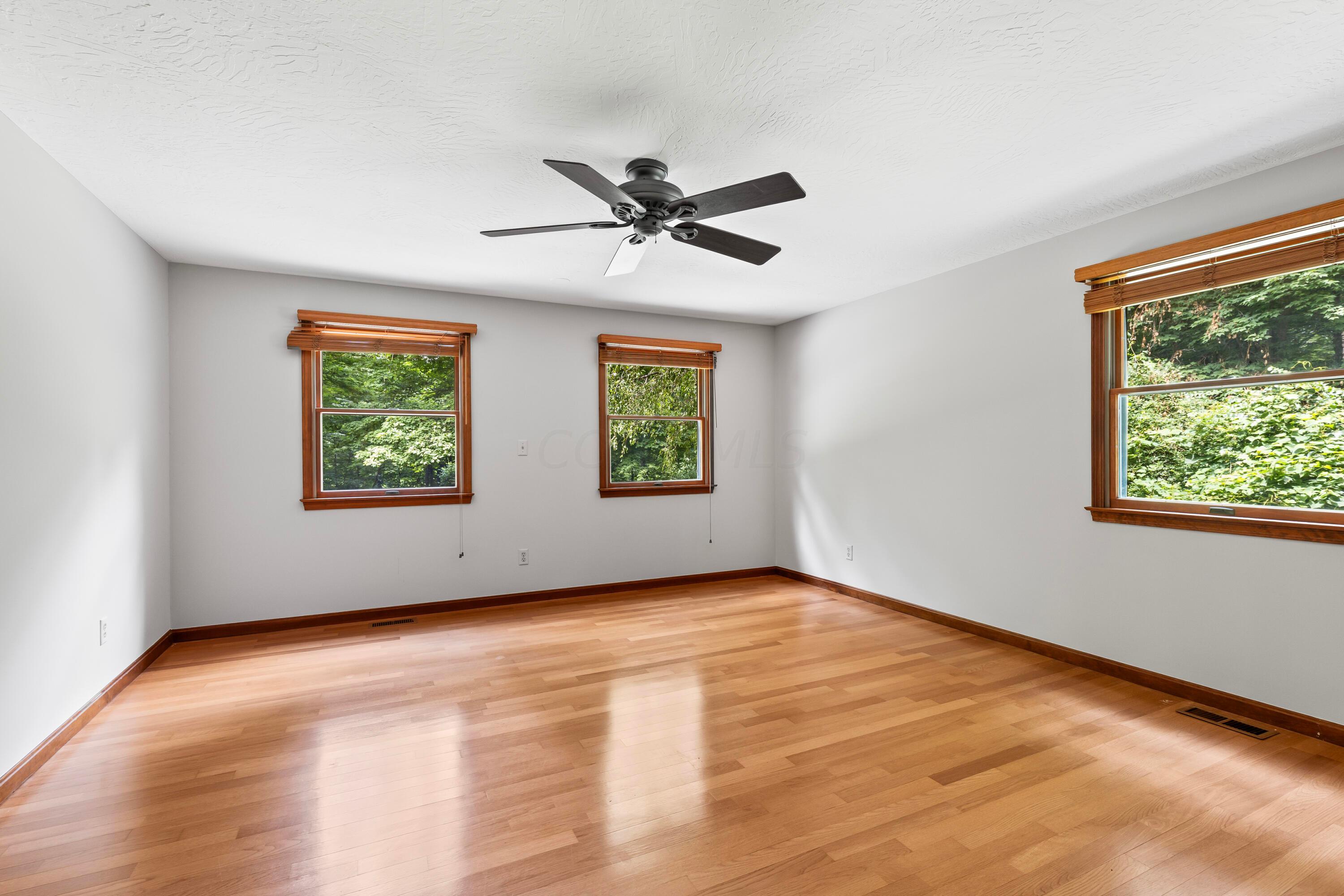 6940 Graham Road Mount Vernon, OH 43050 - Photo 6 of 70 • Hardwood flooring
• Tan painted walls
• Ceiling fan
• 2” wood blinds