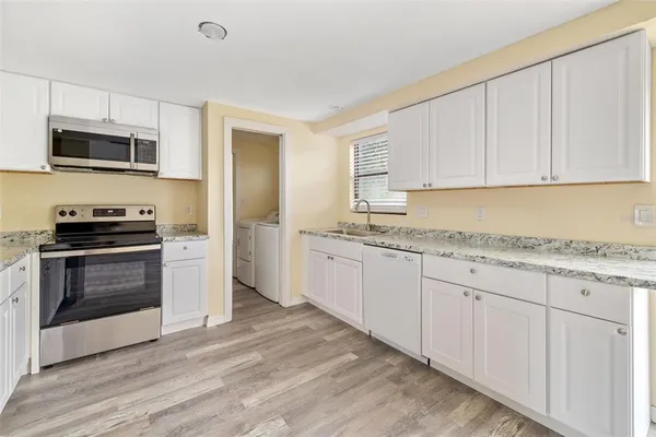 a kitchen with a refrigerator stove and microwave