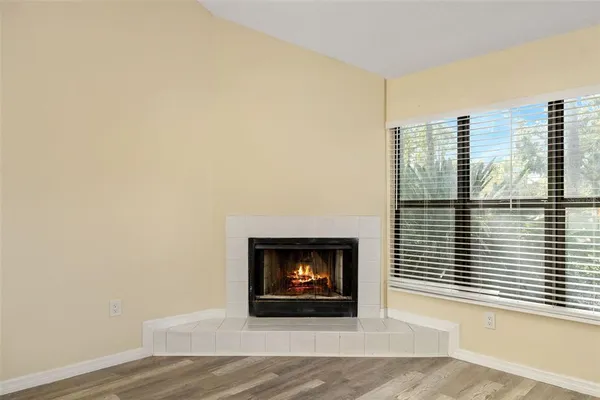 a view of a livingroom with a fireplace and a window