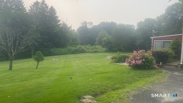 107 Tower Road Brookfield, CT 06804 - Photo 18 of 19 a backyard of a house with lots of green space