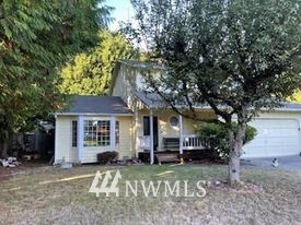 3107 164th Place Southeast Bothell, WA 98012 - Photo 2 of 20 a front view of a house with a yard