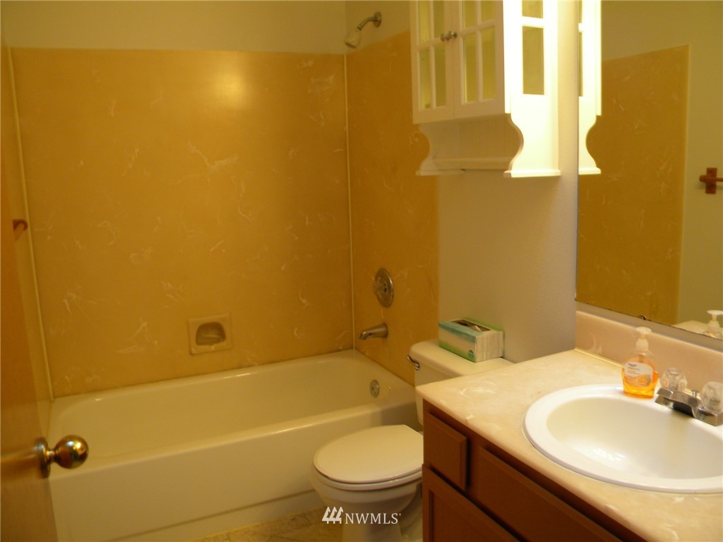 3107 164th Place Southeast Bothell, WA 98012 - Photo 13 of 20 a bathroom with a granite countertop sink and a mirror