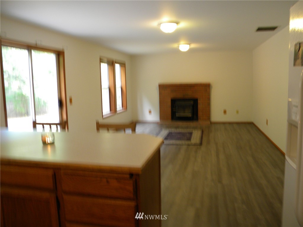 3107 164th Place Southeast Bothell, WA 98012 - Photo 5 of 20 a view of living room with a fireplace and wooden floor