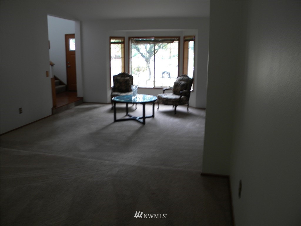 3107 164th Place Southeast Bothell, WA 98012 - Photo 9 of 20 a living room with furniture and a large window