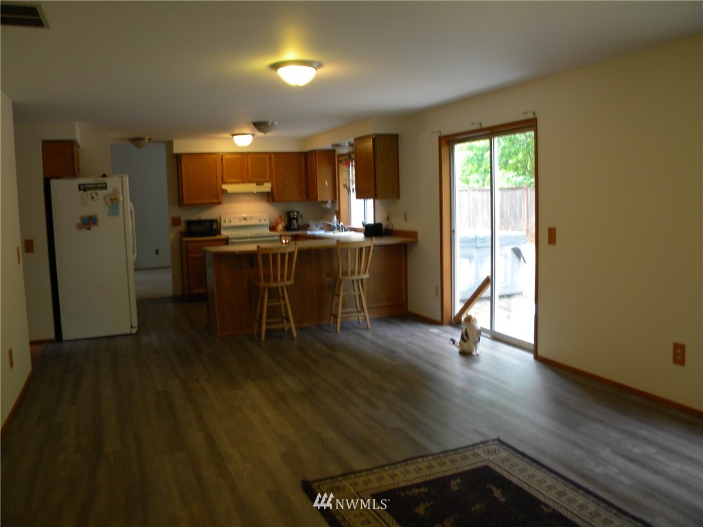 3107 164th Place Southeast Bothell, WA 98012 - Photo 10 of 20 a kitchen with stainless steel appliances a refrigerator a sink a stove and wooden floor