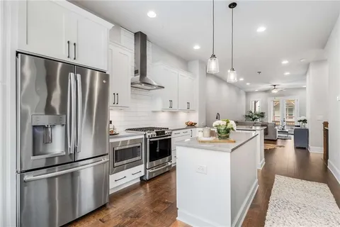 a kitchen with stainless steel appliances kitchen island a refrigerator sink and stove