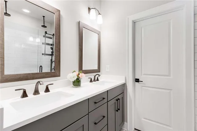 a bathroom with double sink and a mirror