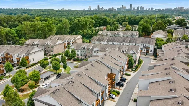 an aerial view of multiple houses with yard