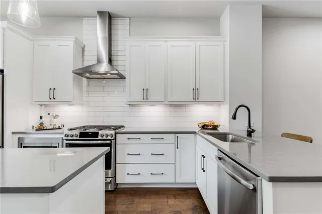 a kitchen with stainless steel appliances granite countertop a sink and cabinets