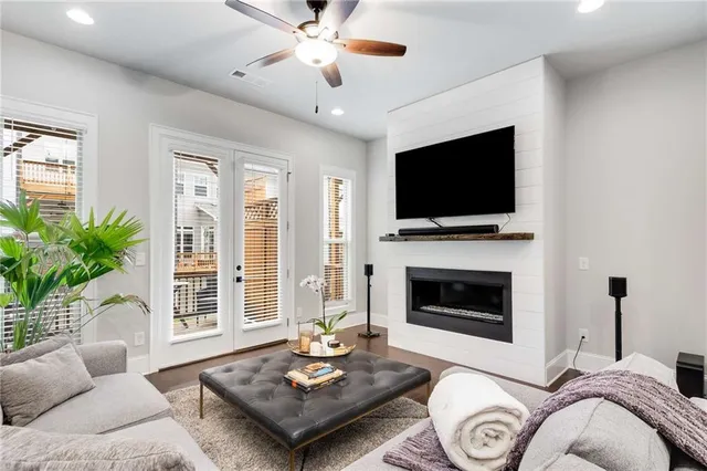 a living room with furniture a fireplace and a flat screen tv