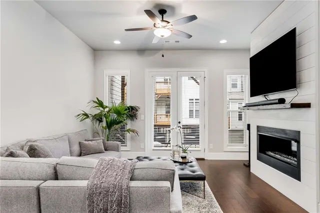 a living room with furniture a fireplace and a flat screen tv
