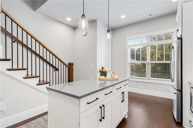 a view of a kitchen with a sink a window and wooden floor