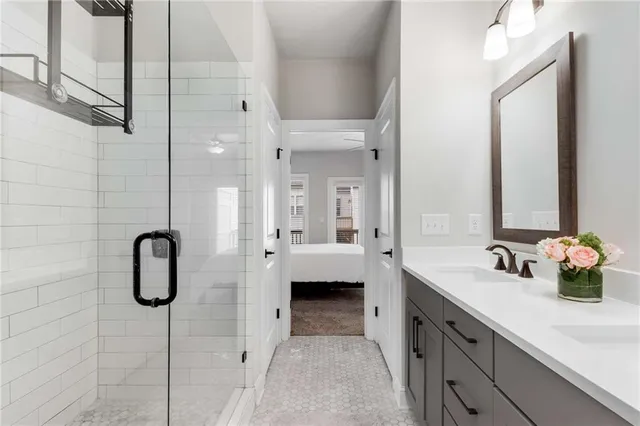 a en suite bathroom with a shower sink and a mirror
