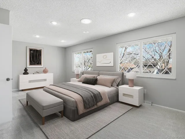 a spacious bedroom with a bed and a large window