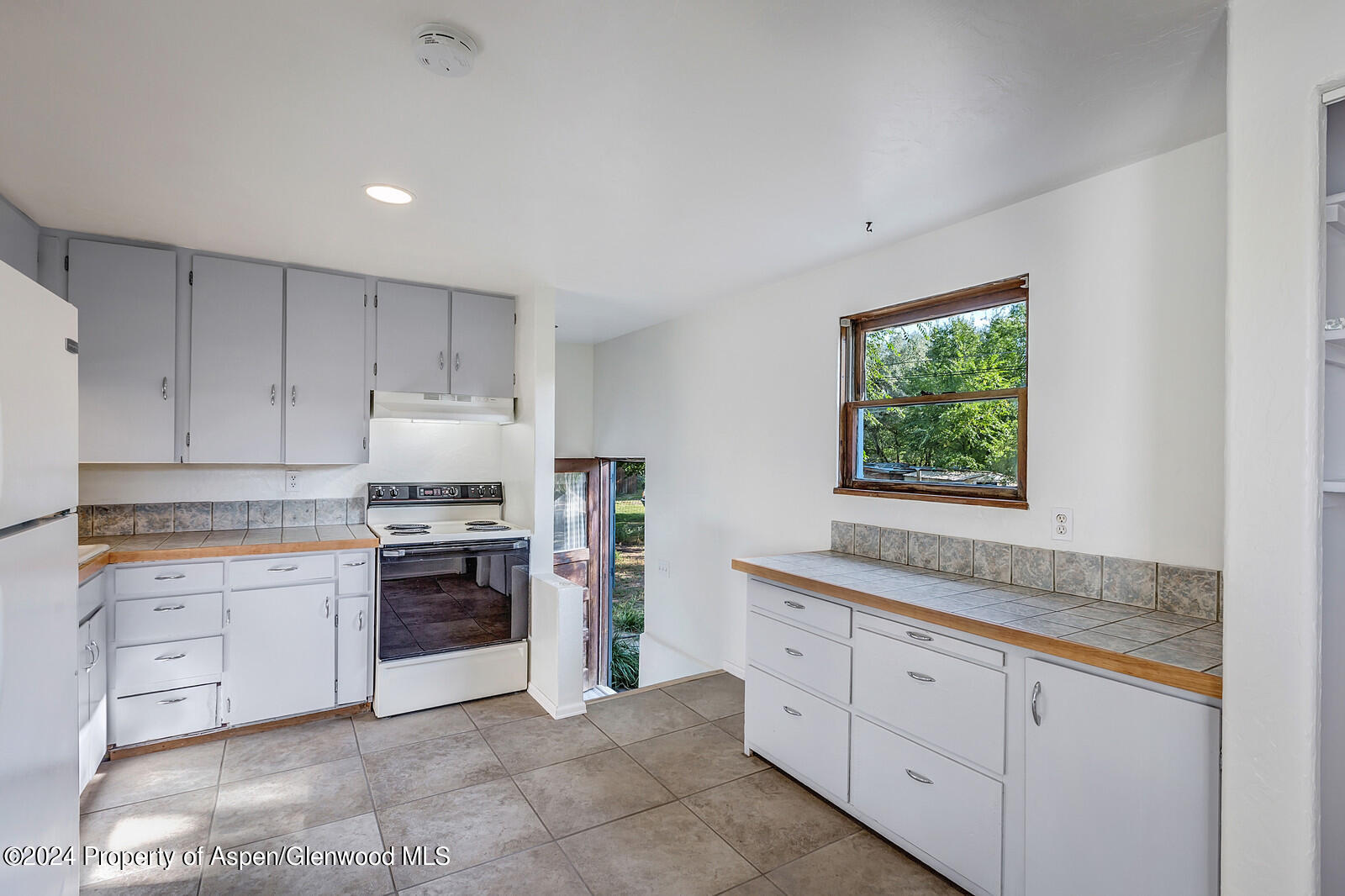 902 Randolph Avenue Rifle, CO 81650 - Photo 5 of 18 a kitchen with granite countertop white cabinets and stainless steel appliances