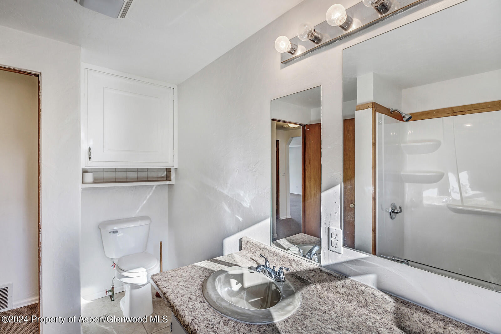 902 Randolph Avenue Rifle, CO 81650 - Photo 10 of 18 a living room with a granite countertop furniture and a mirror