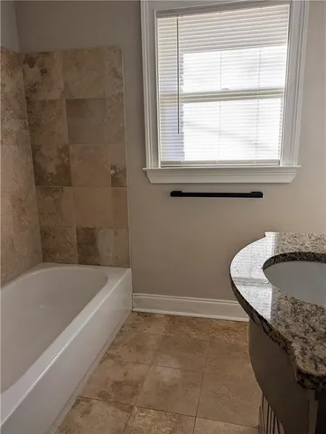 a bath tub sitting next to a window