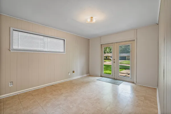 an empty room with window and closet
