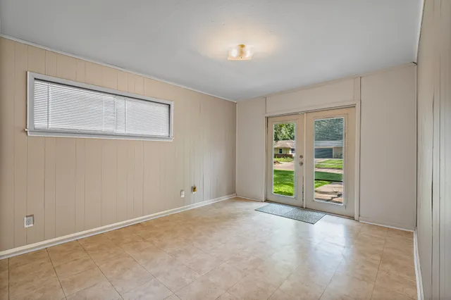 an empty room with window and closet