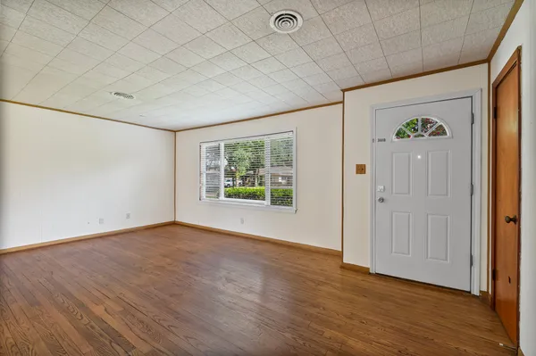wooden floor in an empty room with a window