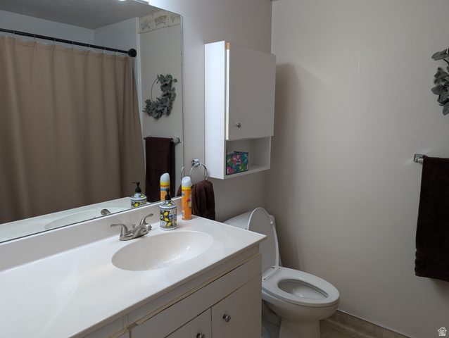1411 Millbrook Way Bountiful, UT 84010 - Photo 18 of 36 Bathroom vanity with integrated sink and chrome faucet, large wall mirror, and overhead cabinet storage