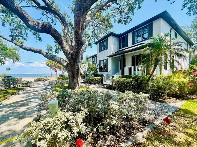 a pathway of a house with a yard