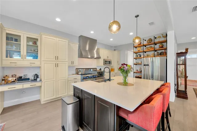 a kitchen with stainless steel appliances granite countertop a stove and a sink