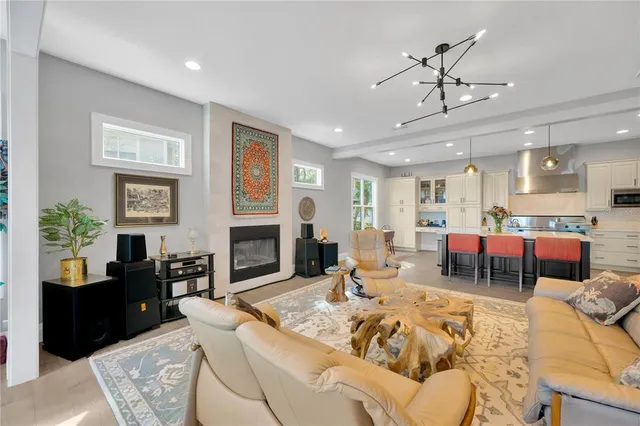 a view of an entryway wooden floor and a chandelier