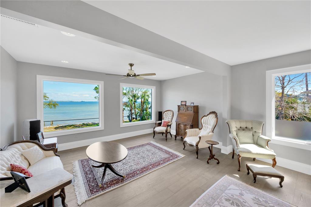 2802 Northpointe Lane Tampa, FL 33611 - Photo 19 of 55 a living room with furniture floor to ceiling window and a flat screen tv