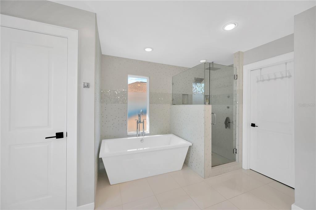 2802 Northpointe Lane Tampa, FL 33611 - Photo 24 of 55 a bathroom with a tub and shower
