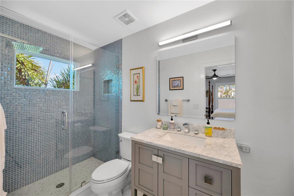 2802 Northpointe Lane Tampa, FL 33611 - Photo 34 of 55 a bathroom with a granite countertop sink a toilet and shower