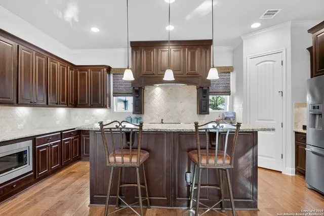 a kitchen with granite countertop a dining table and chairs