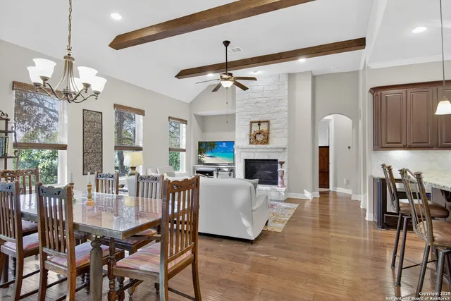 a dining room with furniture a chandelier and window