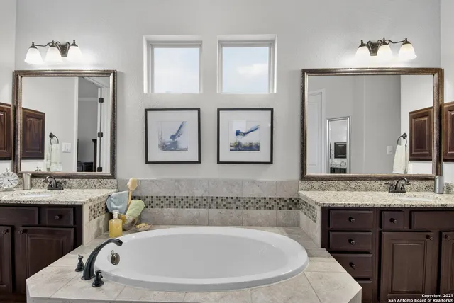 a bathroom with a tub sink and mirror