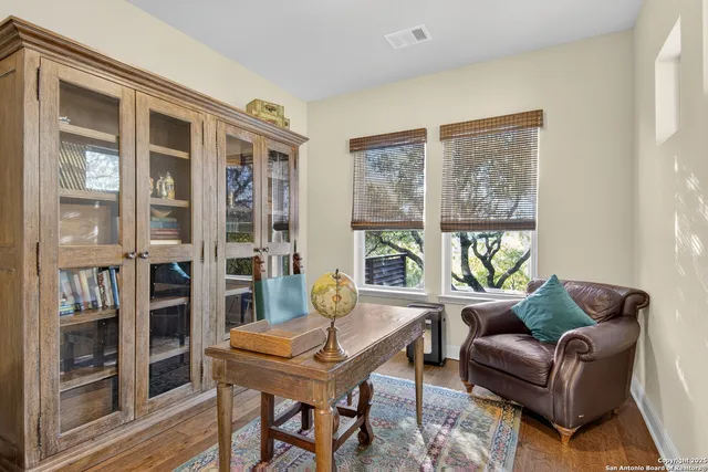 a living room with furniture a table and a large window