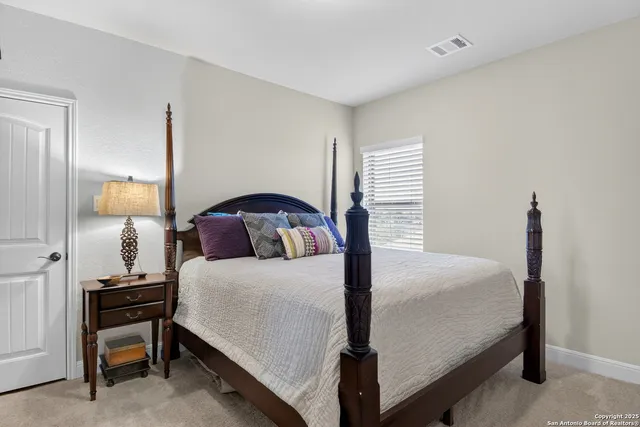 a bedroom with a bed and a mirror